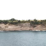 a large body of water next to a cliff